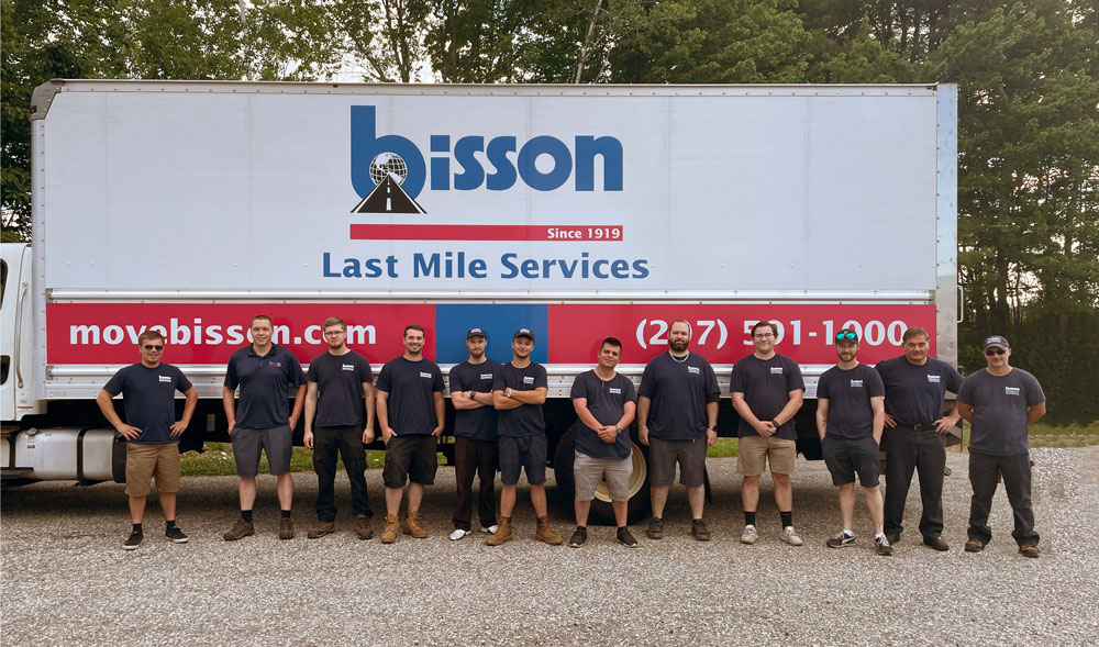 Last Mile Services Group standing in front of a Bisson truck